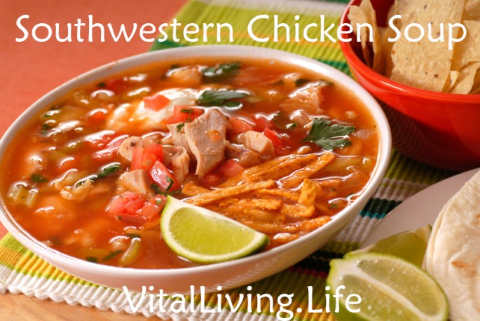 A bowl of chicken and tortilla soup with lime